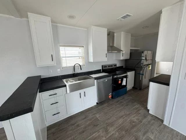 Photo: Kitchen, Landmark 16562L (2BR). Cavco's photo of this model; it can show options and other finishes.