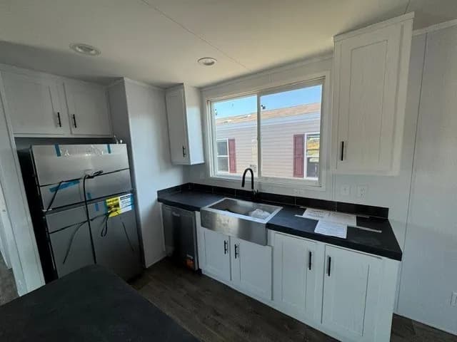 Photo: Kitchen, Landmark 16763A. Cavco's photo of this model; it can show options and other finishes.