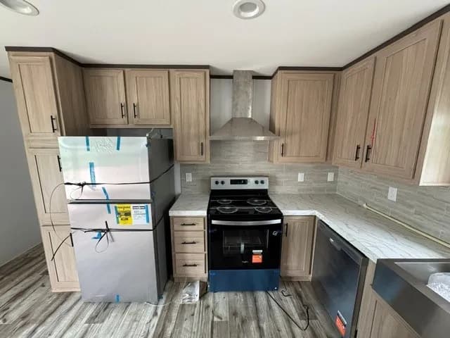 Photo: Kitchen, Landmark 16763B. Cavco's photo of this model; it can show options and other finishes.