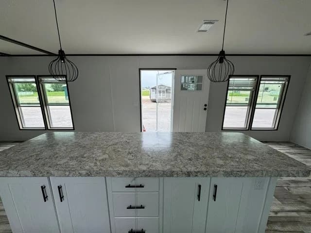 Photo: Kitchen island, Landmark 16763E. Cavco's photo of this model; it can show options and other finishes.