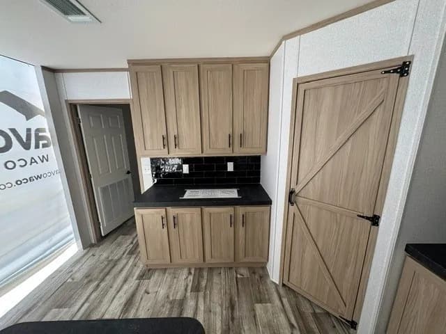 Photo: Kitchen, Landmark 28603U. Cavco's photo of this model; it can show options and other finishes.