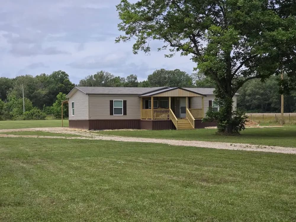 Crystal’s manufactured home set on the property with a covered porch and skirting