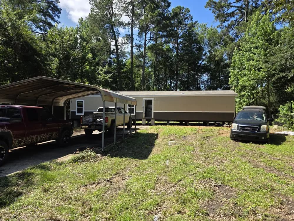 Manufactured home on a wooded Tioga property during installation